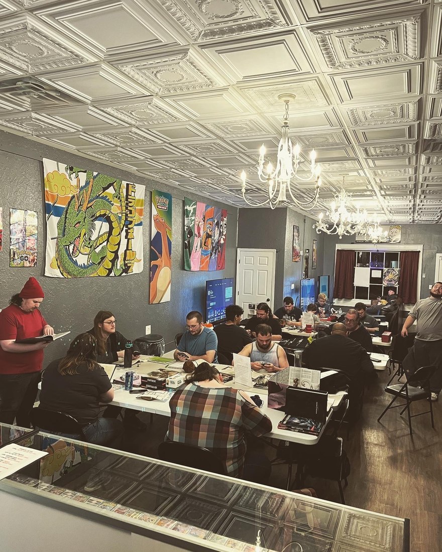 Players gathered at tables for game night at Checkpoint Gaming